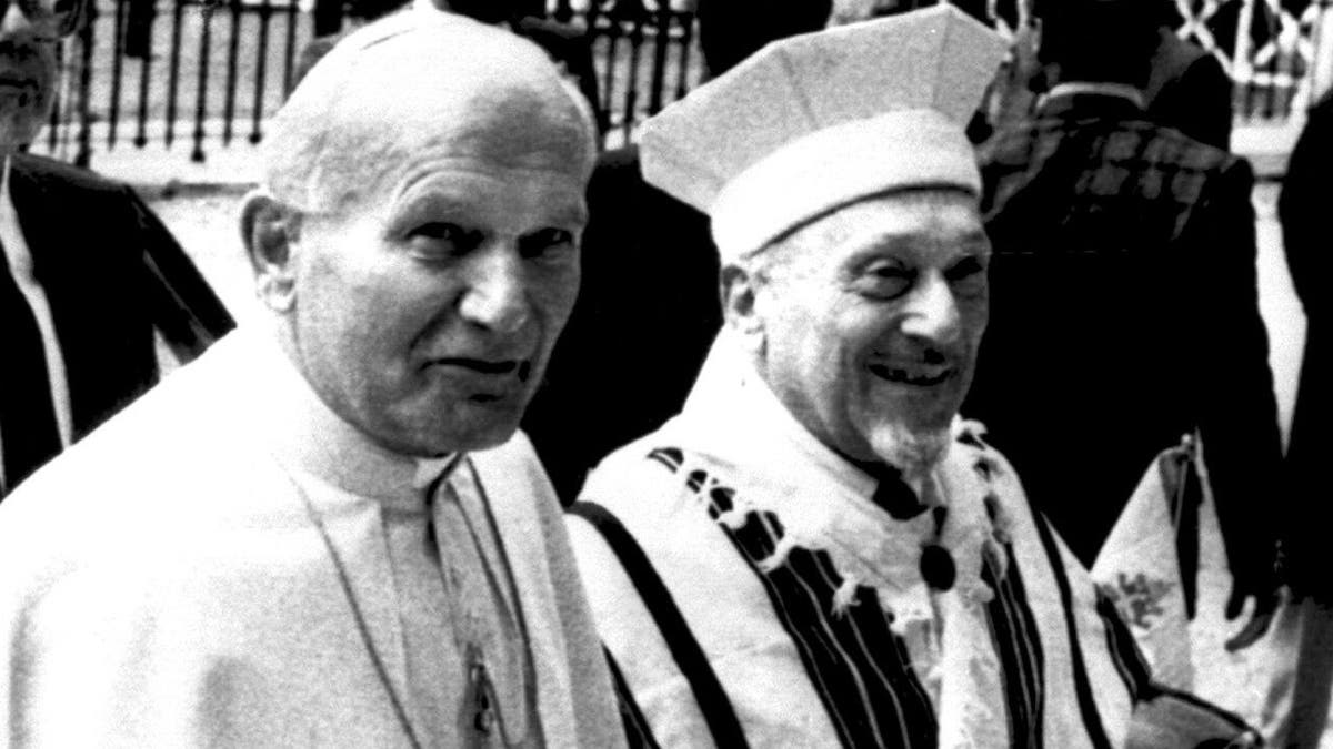 Pope John Paul II is escorted by Rome's Chief Rabbi Elio Toaff as they enter a Synagogue in Rome, Italy on April 13, 1986. It was the first recorded visit by a Pope to a Synagogue. (AP Photo)