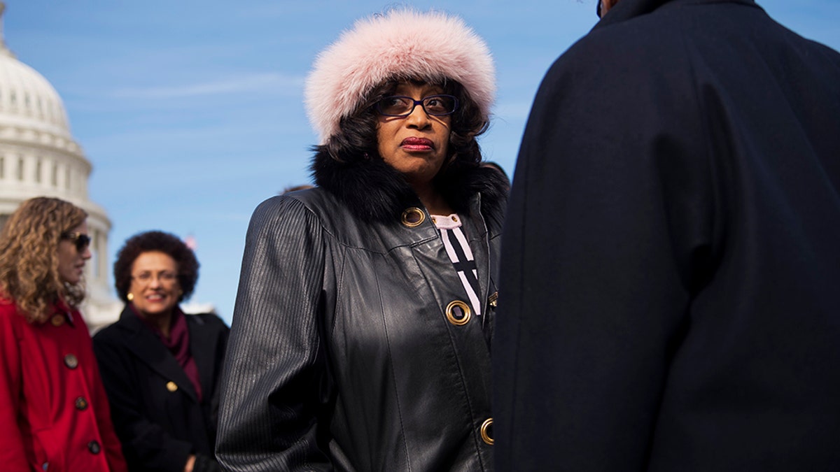 Rep. Corrine Brown in a black outfit and a white hat