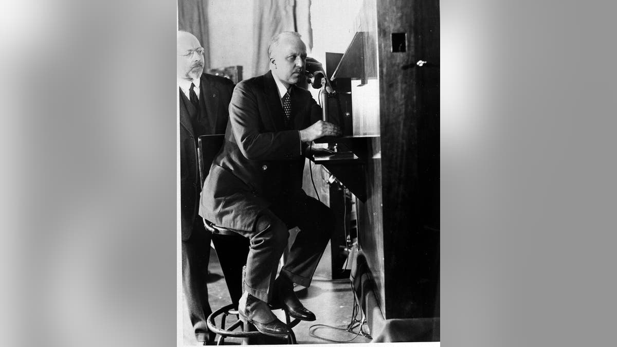 F.B. Jewett, president of A.T.&amp;T. Co. in New York, talks with Secretary Hoover in Washington as he views Hoover's moving image in the small box at eye level. Dr. Herbert E. Ives, who is credited with the invention, looks on. (AP Photo)