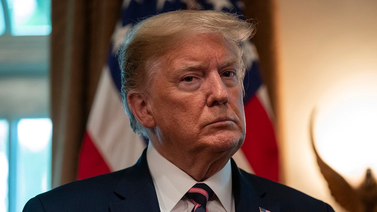 President Donald Trump listens during a demonstration of ways NASA is helping to combat the coronavirus, in the Cabinet Room of the White House, Friday, April 24, 2020, in Washington. (AP Photo/Evan Vucci)