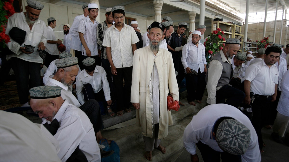 Muslims attend Friday prayers at a mosque in the former Silk Road city of Hotan, Xinjiang province. 