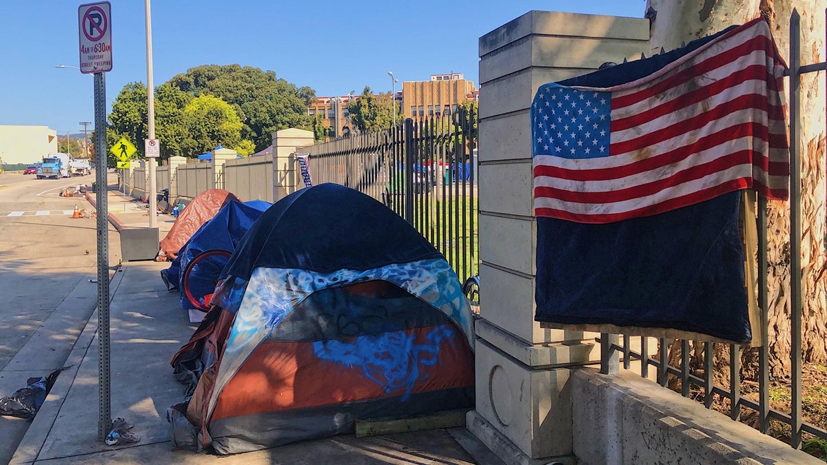 Tents of homeless individuals still line the street outside the VA complex in Los Angeles.