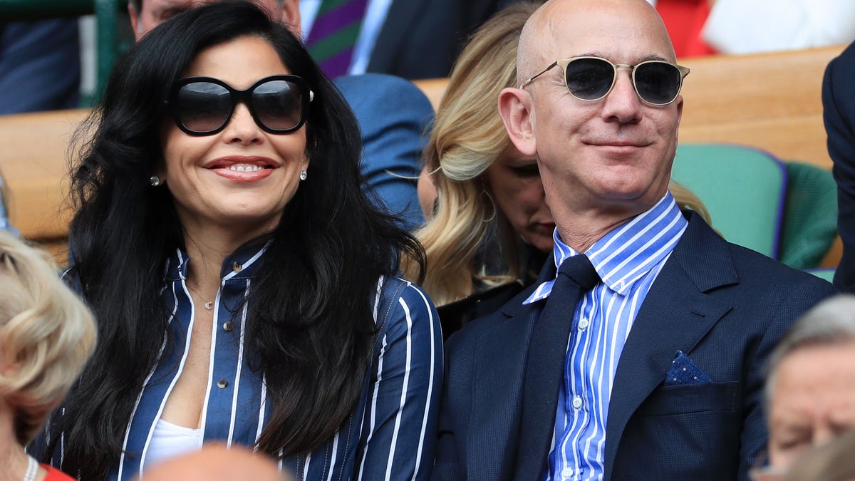 Jeff Bezos and his partner, Lauren Sanchez, look on from the Royal Box on Centre Court on Day 13 of The Championships - Wimbledon 2019 at the All England Lawn Tennis and Croquet Club on July 14, 2019 in London, England. (Photo by Simon Stacpoole/Offside/Getty Images)