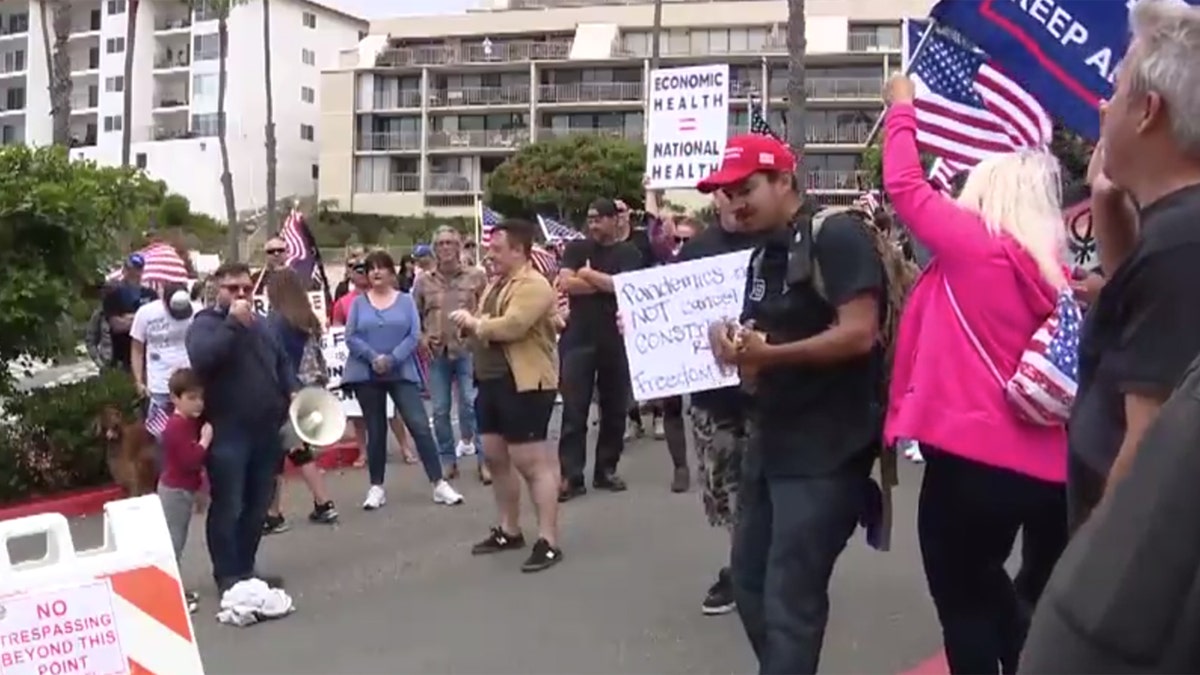 Hundreds gathered Sunday in San Clemente, Calif., gathered to protest California's stay-at-home order meant to slow the spread of coronavirus.