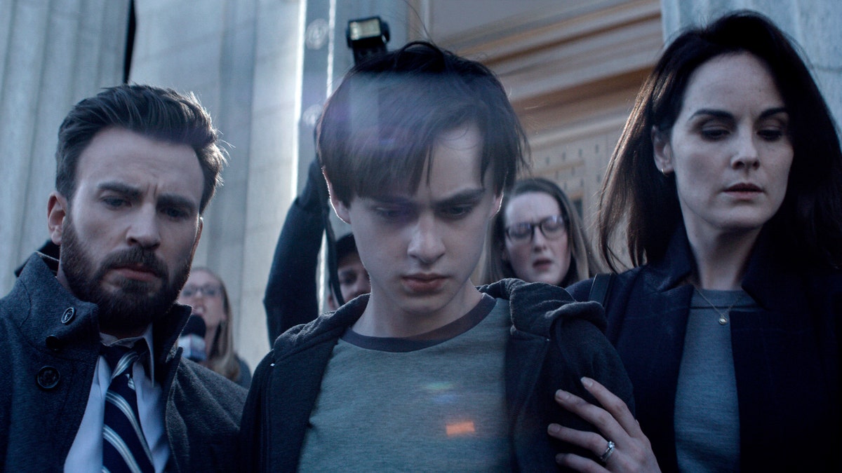 Chris Evans (L) Jaeden Martell (C) and Michelle Dockery (R) in a scene from 'Defending Jacob.'