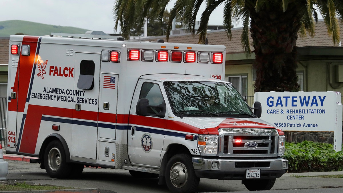 An ambulance leaves the Gateway Care and Rehabilitation Center on Thursday. At least 13 patients at the facility have died of coronavirus, and 41 others have been infected.