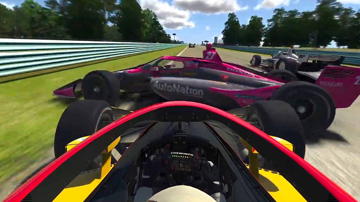 In this image taken from a video provided by iRacing IndyCar, IndyCar driver Kyle Kirkwood, foreground, collides with Alexander Rossi (27) during the early running of the American Red Cross Grand Prix virtual IndyCar auto race at Watkins Glen International, Saturday, March 28, 2020. (iRacing IndyCar via AP)