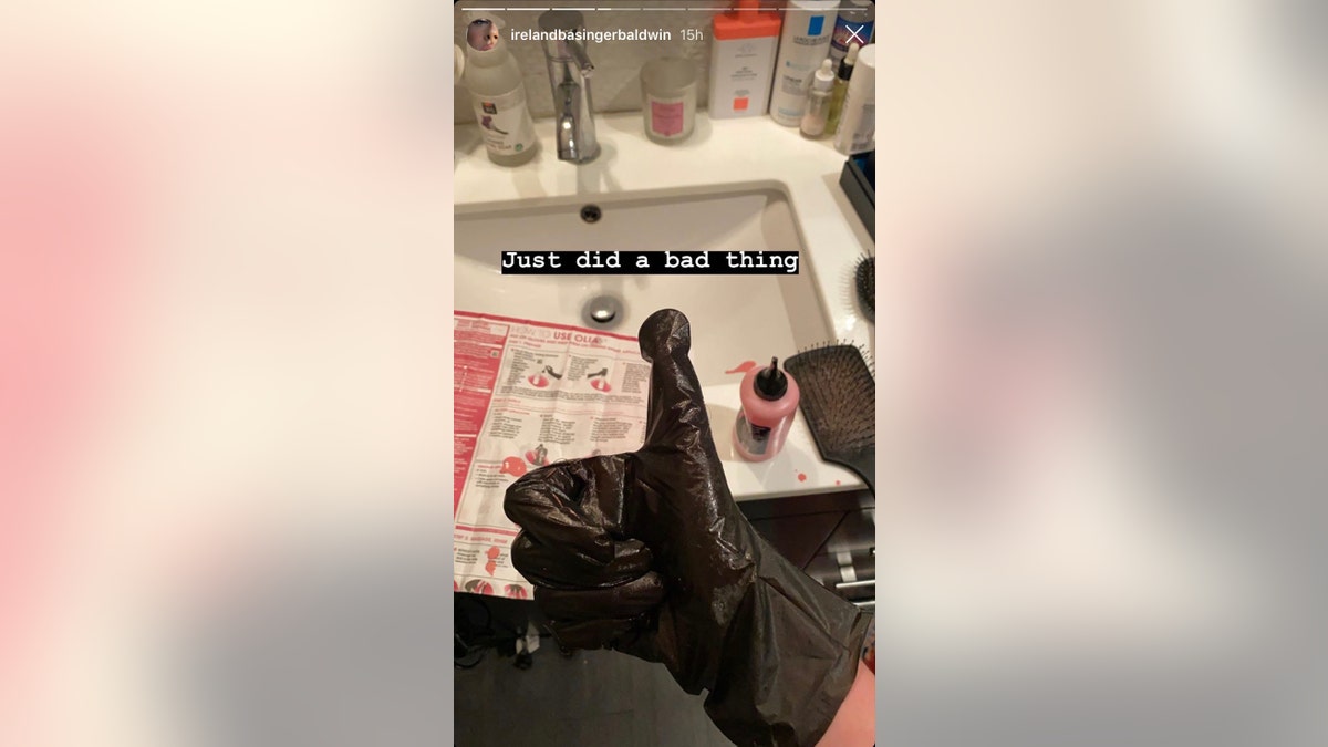 Ireland Baldwin shows off the process of dying her hair pink.