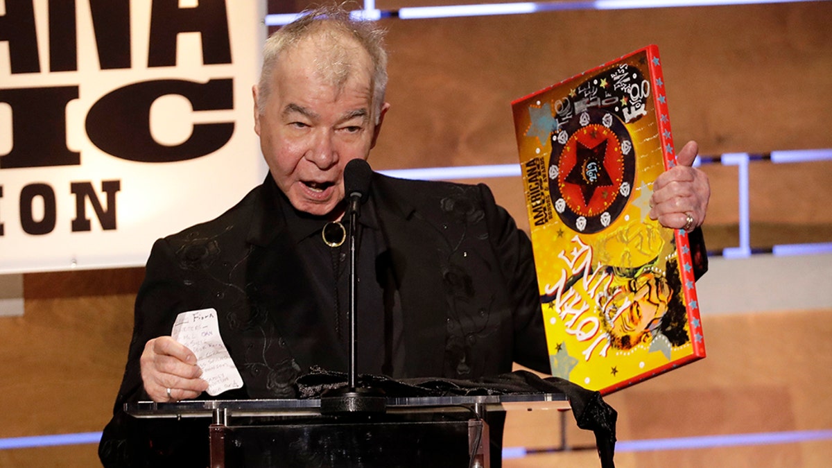 FILE - In this Sept. 11, 2019 file photo, John Prine accepts the Album of the Year award at the Americana Honors &amp; Awards show in Nashville, Tenn. 