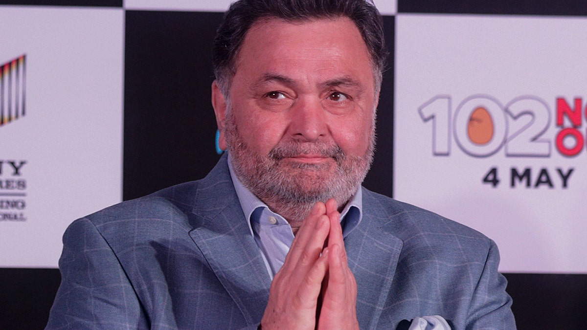 In this April 19, 2018 file photo, Bollywood actor Rishi Kapoor greets media as he arrives for the song launch of film '102 Not Out' in Mumbai, India. 