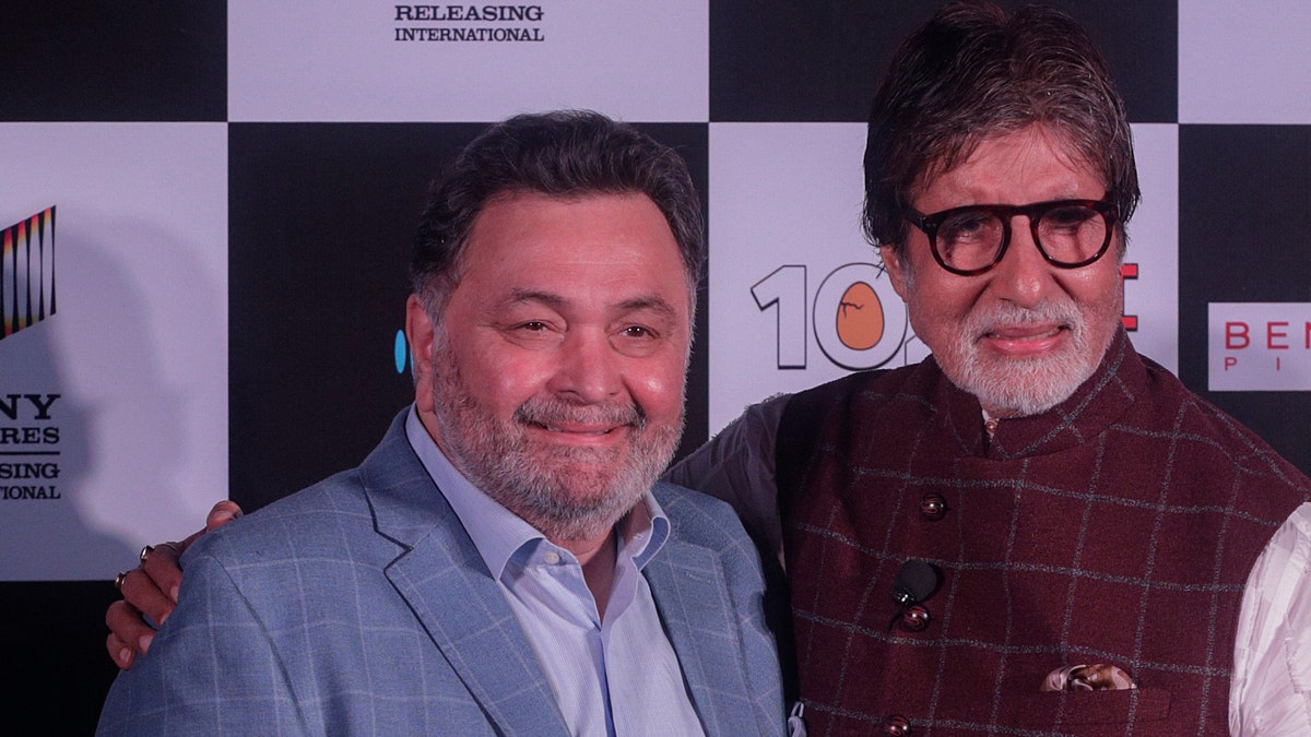 Bollywood actor Rishi Kapoor, left poses with actor Amitabh Bachchan the song launch of film '102 Not Out' in Mumbai, India. 