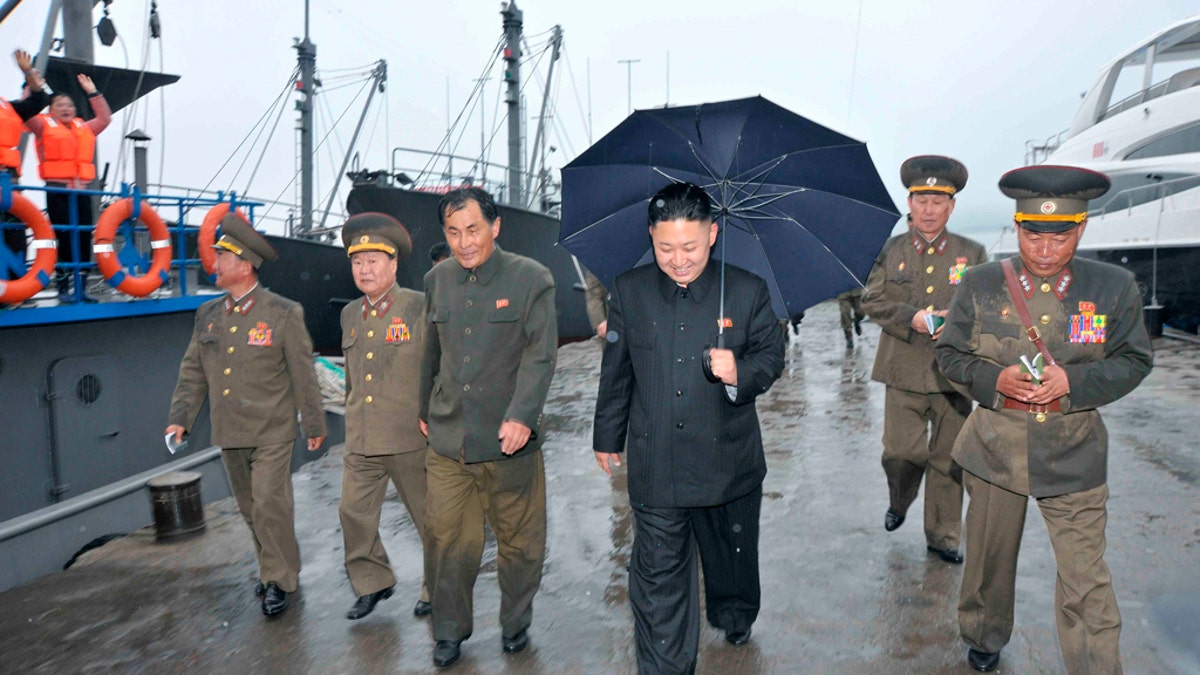 Kim Jong-un is seen inspecting the fishery station at Wonsan on North Korea's east coast in thie 2013 photo, with a luxury yacht seen in the background.