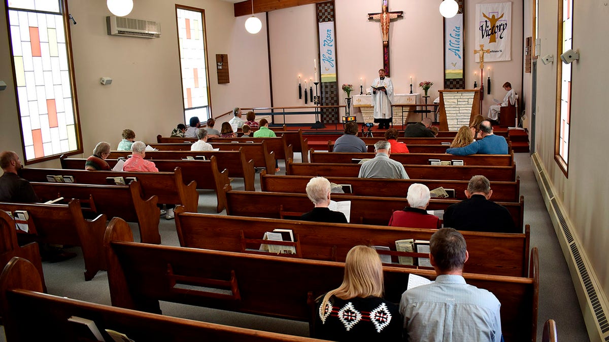 Members of Christ the King Lutheran Church in Billings, Montana sing a hymn during a service Sunday following a phase-in reopening of businesses and gathering places as infection rates from the coronavirus decline in the state. (AP Photo/Matthew Brown)