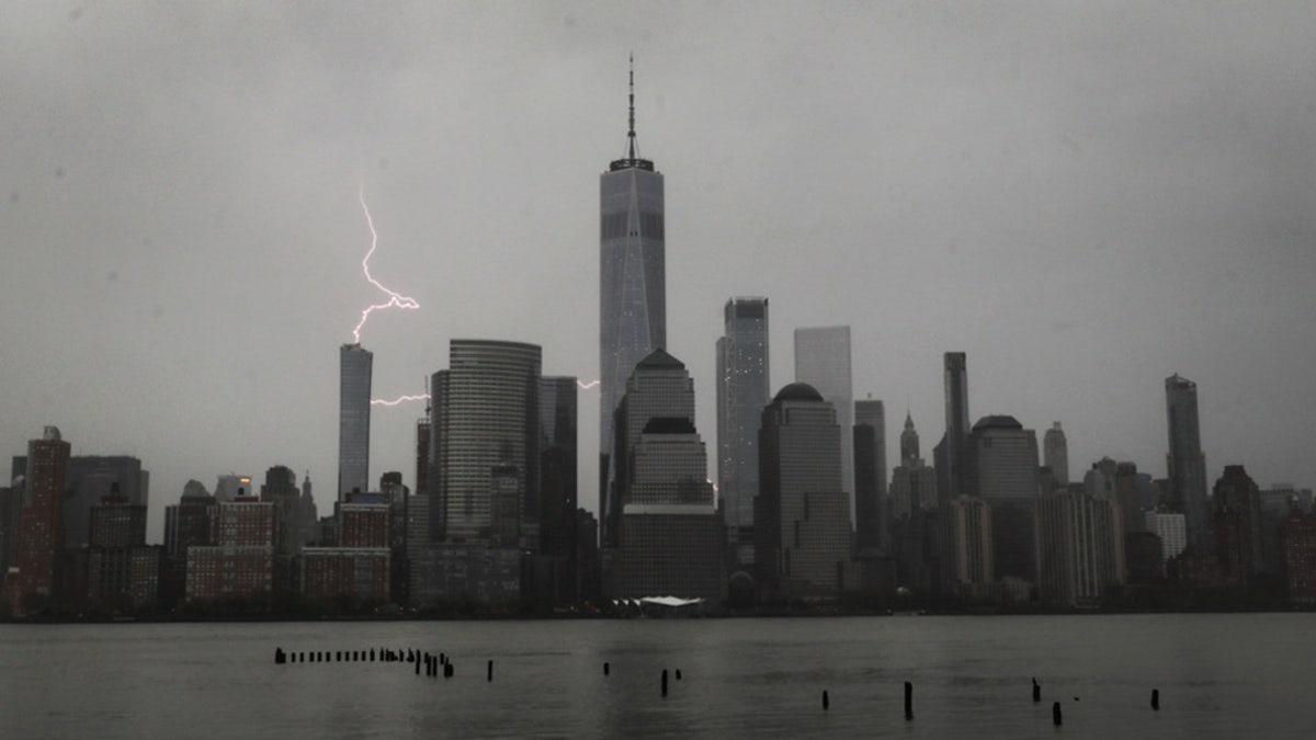 Lightning strikes behind lower Manhattan and One World Trade Center during a thunderstorm in New York City, April 21, 2020.