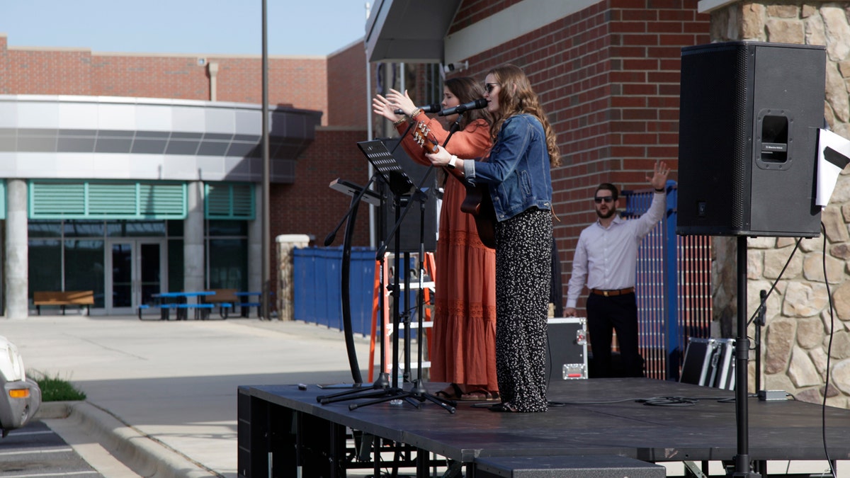 Kensley Husband and Chelsea Locklear lead the congregation in "Jesus Paid It All" during a drive-in Easter service held by the Relevant Church on Saturday, April 11, 2020, at the YMCA parking lot in Clover, S.C.