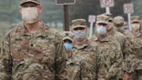 U.S. Army Reserve Urban Augmentation Medical Task Force Soldiers prepare to board buses at Joint Base McGuire-Dix-Lakehurst, New Jersey, to deploy to community hospitals, April 08, 2020.