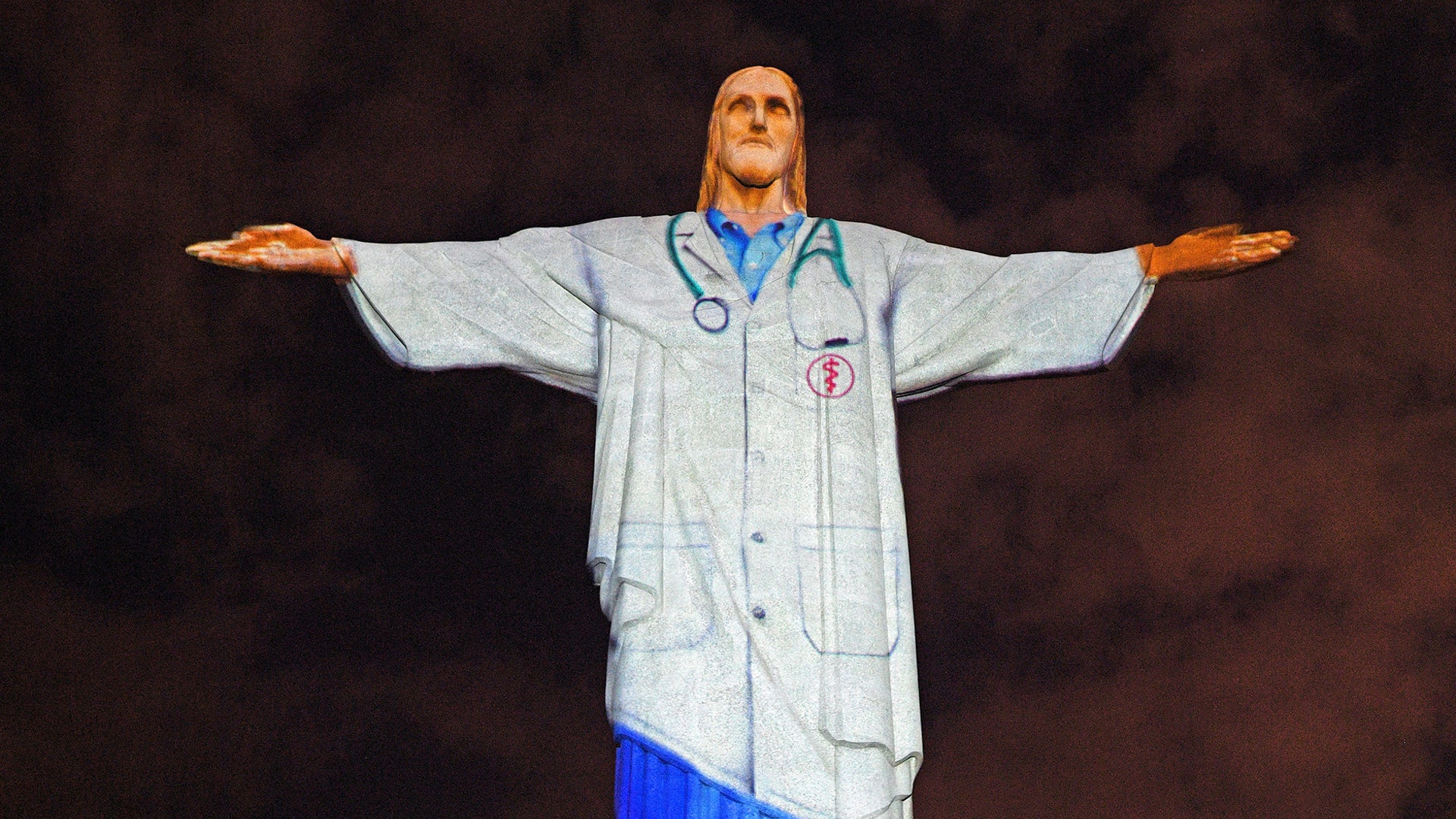 The Christ the Redeemer statue is lit up with a doctor's uniform projected on it in honor of all the medical staff fighting the COVID-9 coronavirus pandemic worldwide in Rio de Janeiro, Brazil on April 12, 2020.