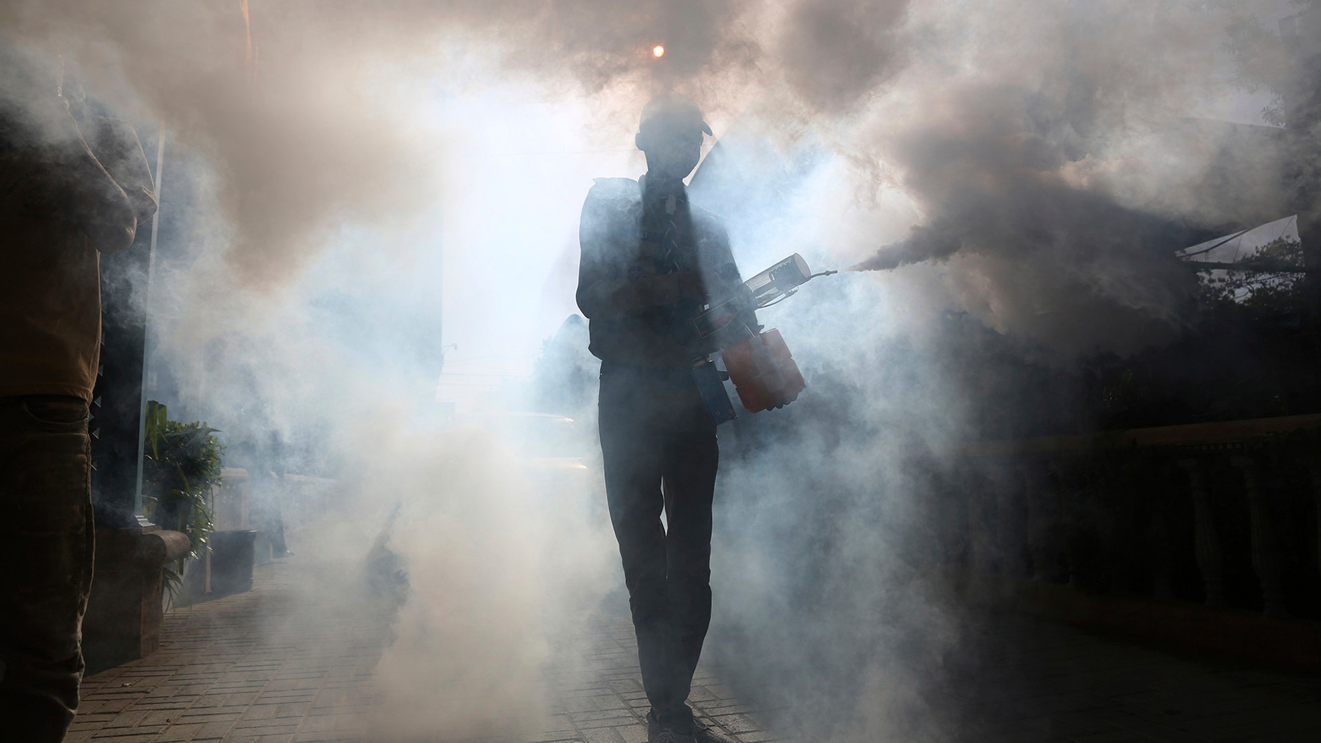 A volunteer disinfects the Karachi Press Club building in an effort to contain the outbreak of the coronavirus, in Karachi, Pakistan, April 13, 2020.