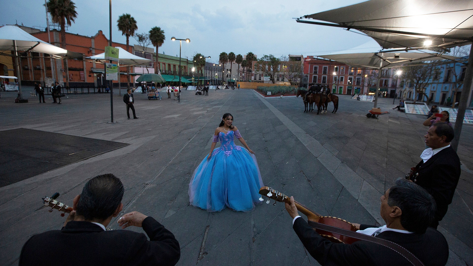 Quinceanera Ximena Ferrusquilla dances in the now-empty Garibaldi Square as mariachis perform in her honor to mark her 15th birthday in Mexico City, April 3, 2020.