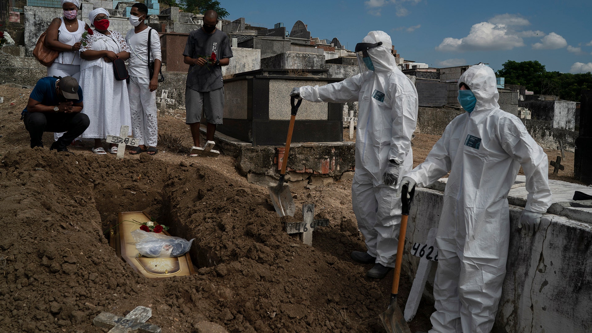 Taina dos Santos attends the burial of her mother Ana Maria, a 56-year-old nursing assistant who died from the coronavirus, in Rio de Janeiro, Brazil, April 28, 2020. 