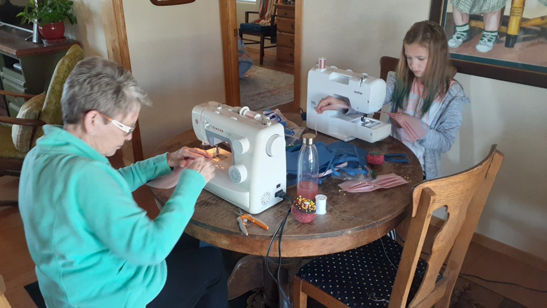 Cindy Owen's (Granny) and (10 year old grand-daughter) Beau Owens sew masks for St.Marys Hospital in Grand Junction, Colorado with others from the Fruita 2nd. Ward of the Church of Jesus Christ of Latter Day Saints.
