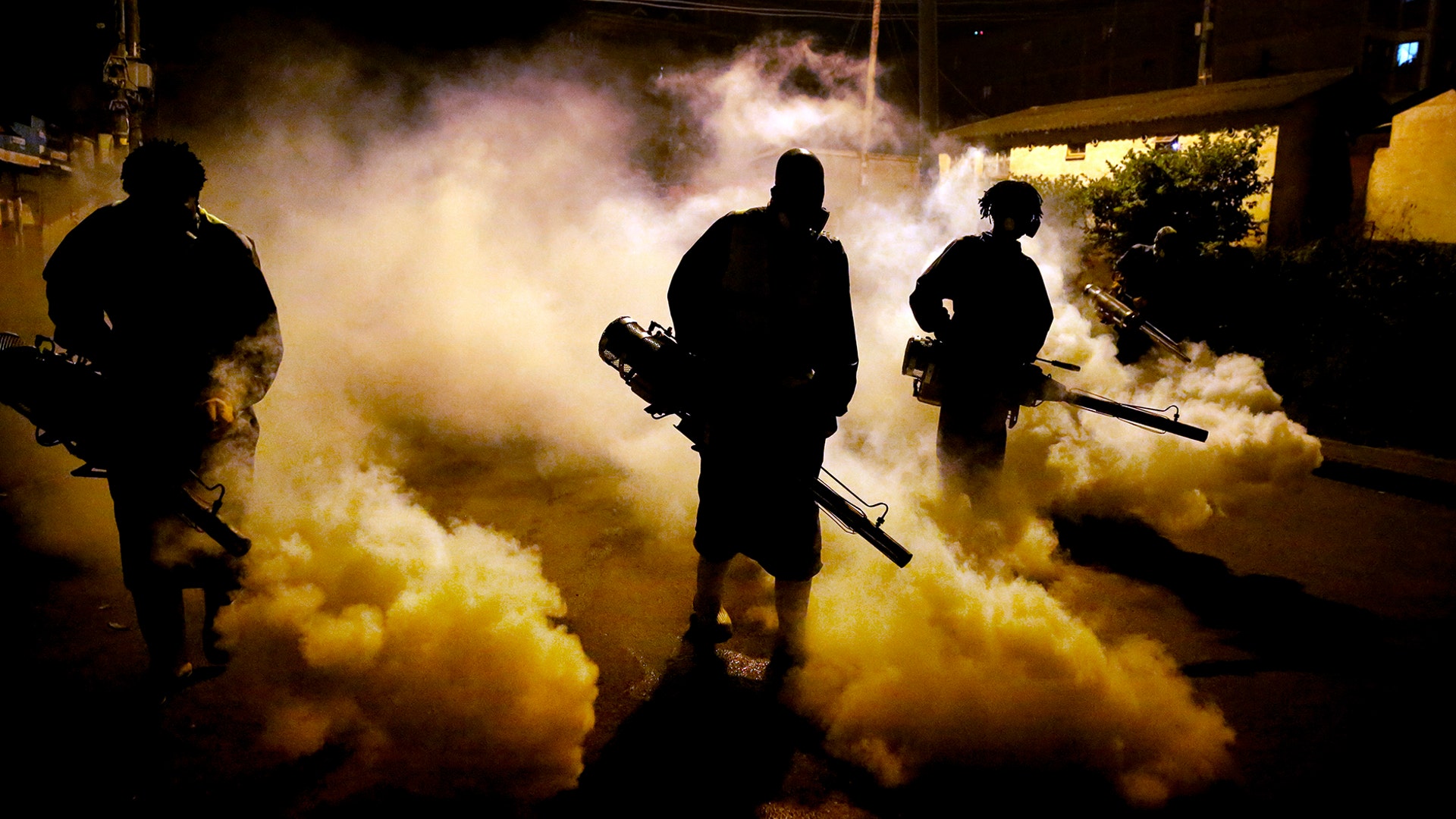 Members of a privately funded non-governmental organization working with county officials disinfect a street to help curb the spread coronavirus, during the dusk-to-dawn curfew in Nairobi, Kenya, April 9, 2020.
