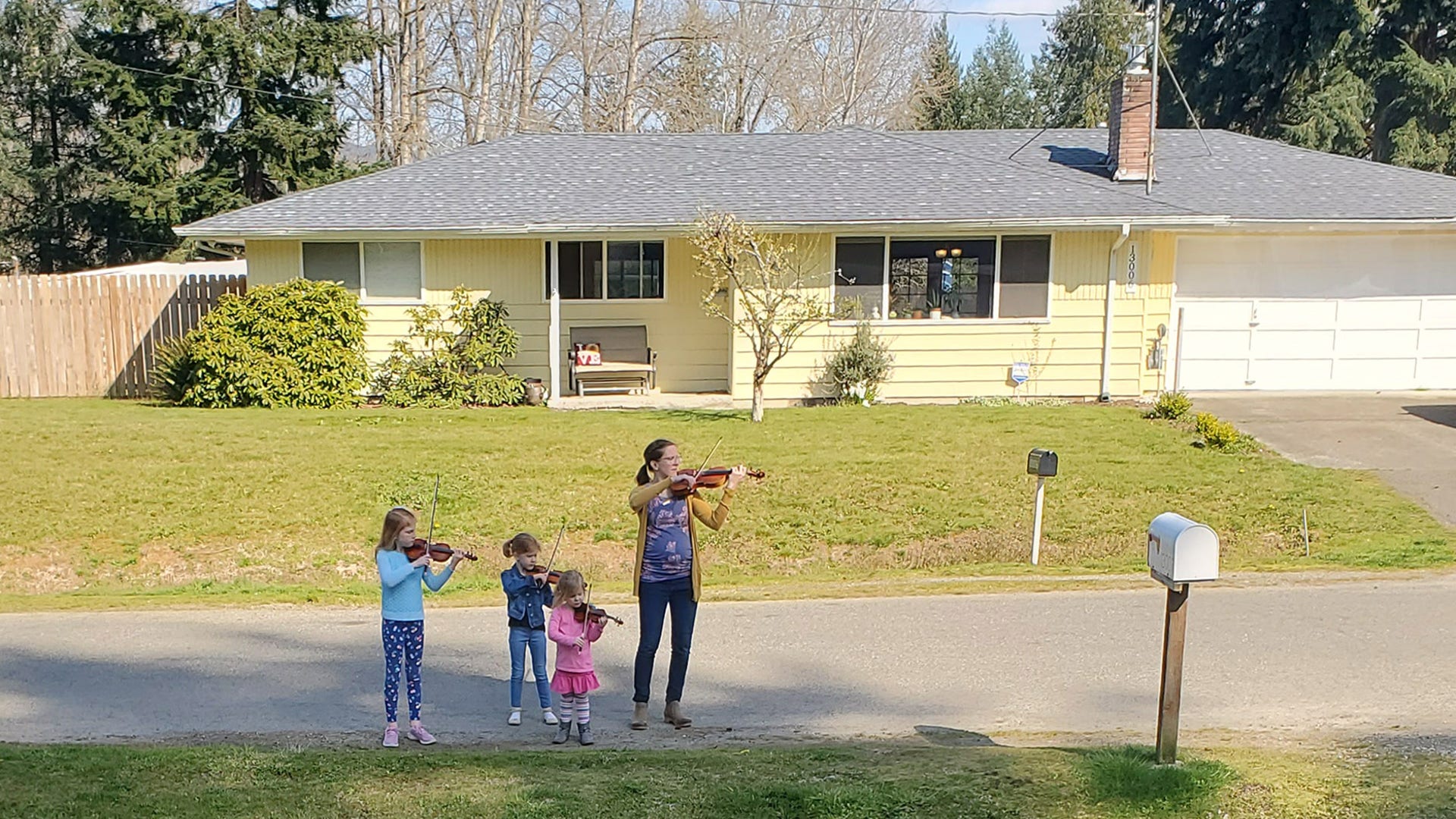 This mom with her 3 daughters walked through the neighborhood serenading anyone outside on April 7th 2020. Renton Washington What a joy! They played for me Old Joe Clark.