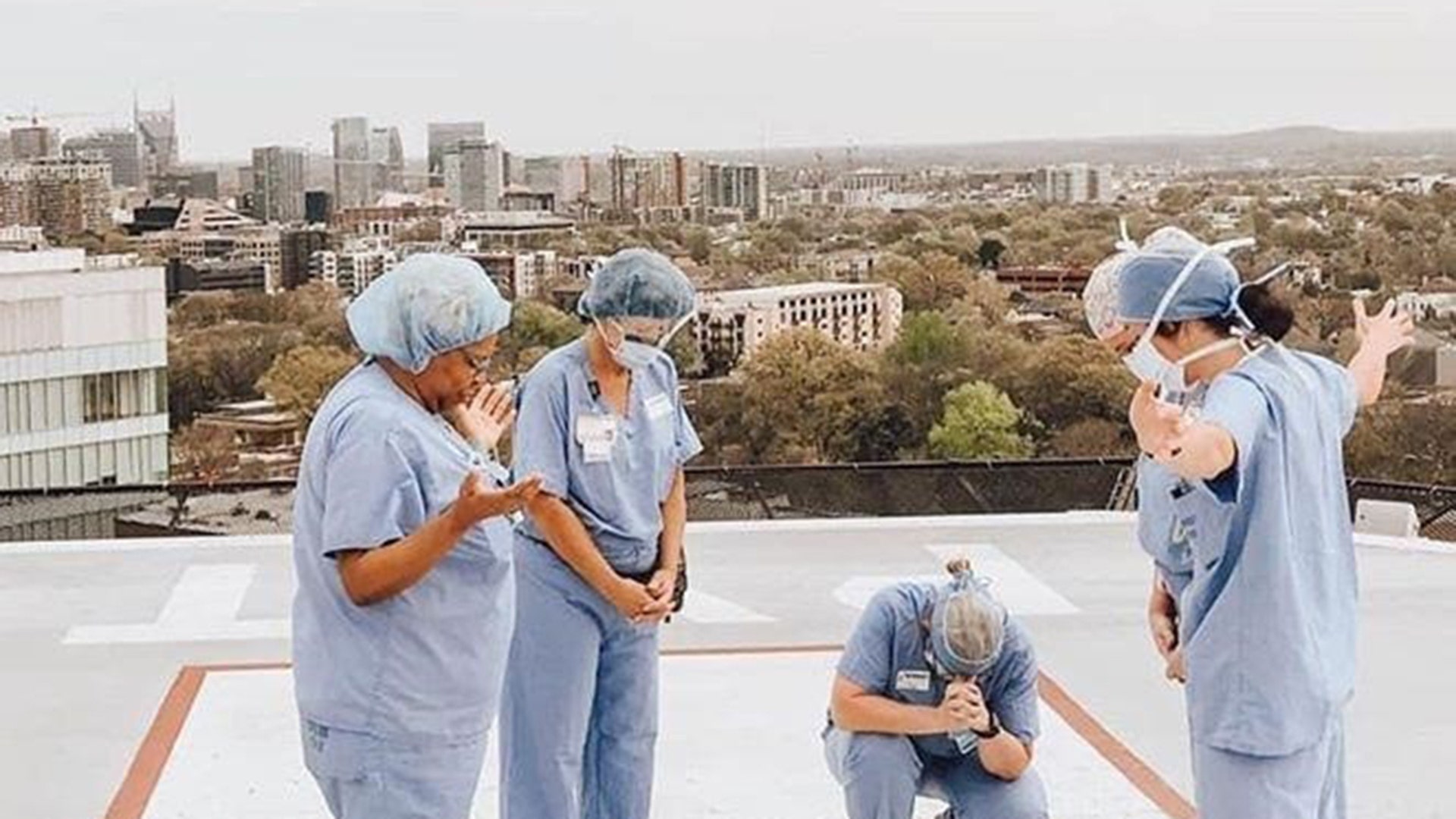 Nurses and surgical techs praying those impacted by CV19 on the roof of Vanderbilt University Medical Center
