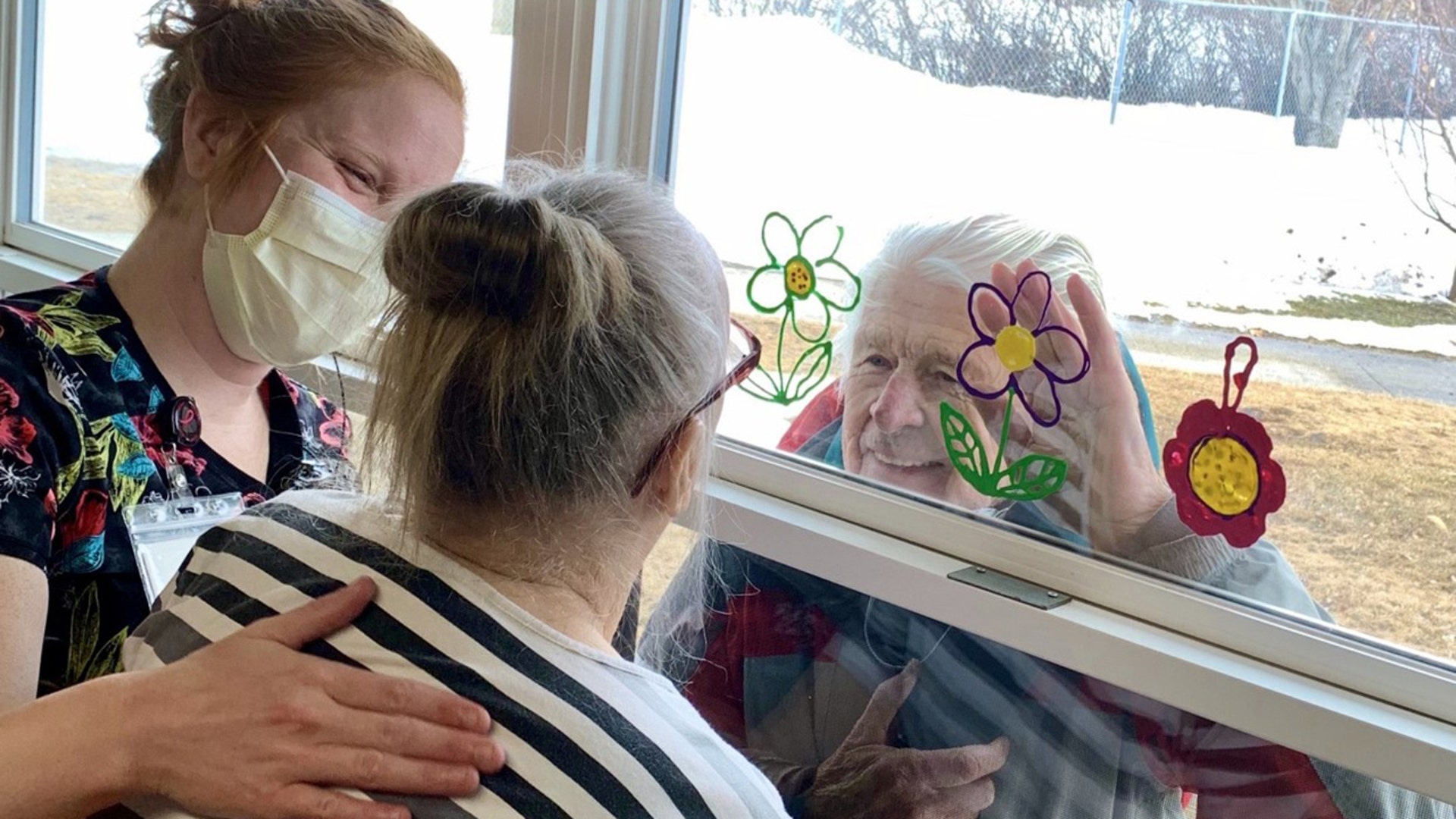 This photo is of my dad (Wayne Dahl) visiting my mom (Nancy) at the McIntosh Senior Living Center (dementia unit) in the small town of hMcIntosh, Minnesota. My mom was diagnosed approximately 10 years ago with early onset dementia and my dad has been her primary caregiver up until about three years ago. He usually spends each day with her at the center from early morning until she goes to bed in the evening. Currently, he is able to visit her daily only through the window of her room with the assistance of the nurses and aids. This means so much to him and we are so grateful for their care and kindness to help make this very difficult time a little easier.
