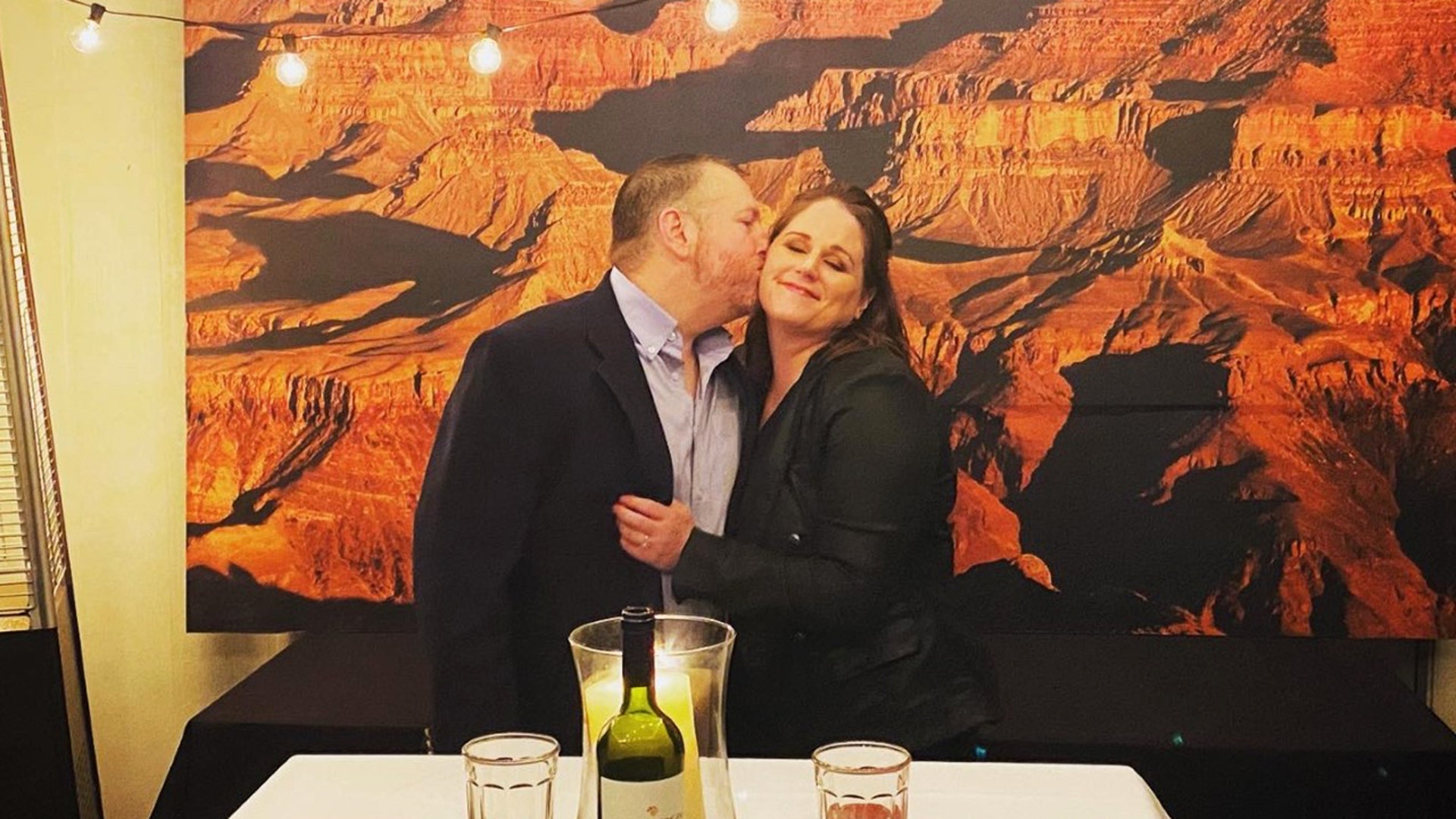 My name is Amber Peterson from McAllen, TX. I wanted to share a feel good story that happened to me last week down here in Southern Texas. My boyfriend, Jason, and I had a trip planned last week to the Grand Canyon that was unfortunately cancelled due to the virus. We are both federal law enforcement agents with varying schedules, which limits our time together on a daily basis. Needless to say we were really looking forward to this time together and enjoy the amazing national park. Jason seemed even more disappointed than me that our trip was cancelled, which was fairly surprising since he’s normally a very go with the flow kind of guy. Little did I know he had something special planned during our trip. So last Wednesday, the day we were to arrive at the Grand Canyon, I went over to his house for dinner. To my surprise he was all dressed up and walked me to his backyard where he had set up tables, candles, lighting and a huge wall art canvas of the Grand Canyon! He had got curbside pickup for Texas Roadhouse and a tiramisu from our favorite local Italian restaurant Colletti’s in Harlingen, TX. If the special dinner and decorations were not enough to boost my spirits, he asked me to Marry Him!!!! I said YES!!! I was beyond surprised and overjoyed that during a time of such confusion and stress we could escape the reality of the world around us and celebrate our love. His original plan was to propose at the Grand Canyon of course, but he had to adjust. As a law enforcement agent he has spent years adapting and overcoming challenging situations and this was no different. He found a way to bring the Grand Canyon to us and make it even more memorable!!! We are looking forward to making that trip a reality at some point to see it’s majestic beauty in person, but until then we have one very large picture to remind us of our dream and future together!!! I hope our story of interrupted plans and making the best out of a bad situation, all while making time for