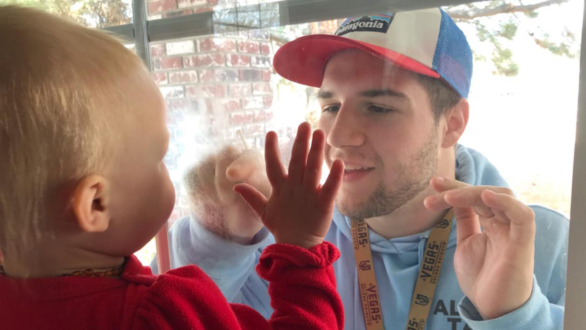 Hello. This cute shot is of my son Brendan saying hello to his niece Holly through a window in Sparks, Nevada. Bill Kane
