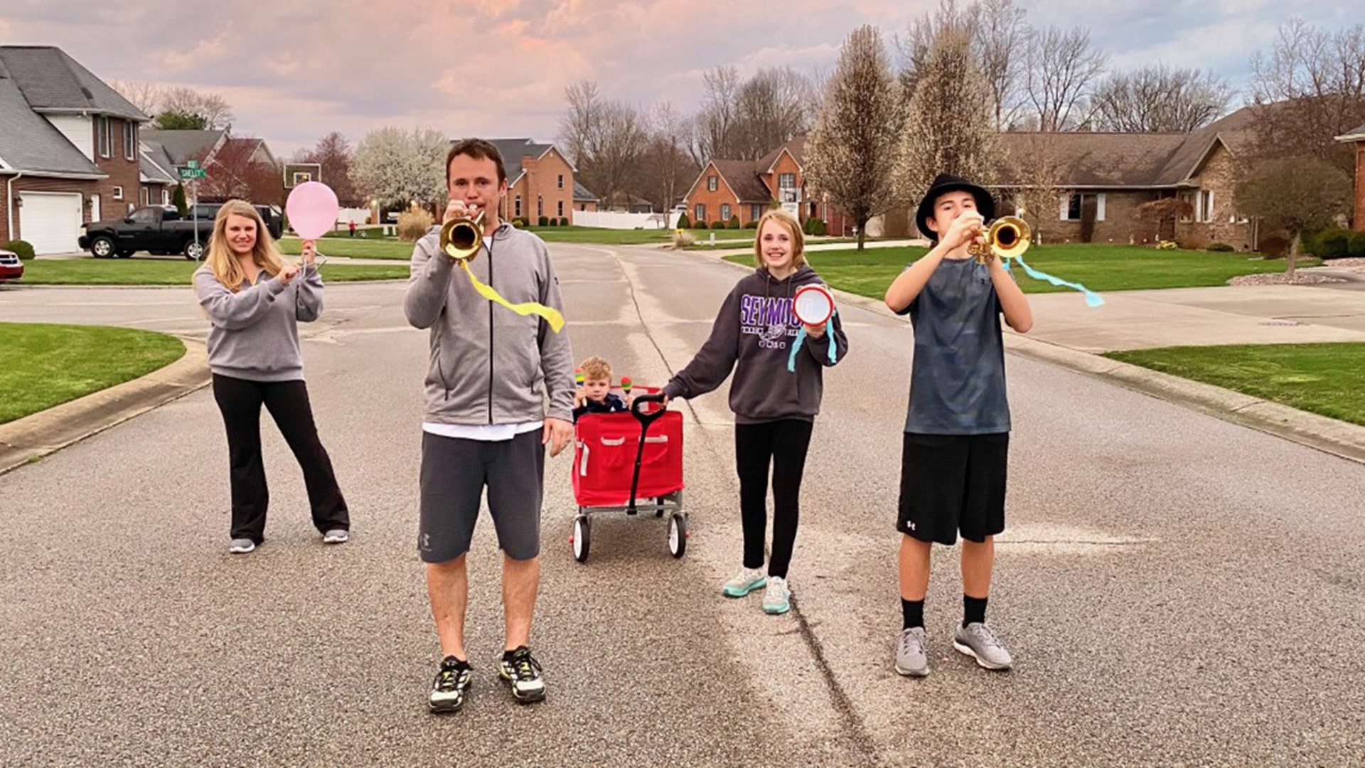 Making the best of a difficult time. The Marks Family walking around the neighborhood. As we walked single file past our neighbors sitting along the edge of the street on opposite sides from each other , someone yelled "how about a fanfare!" Little did they know we had a few trumpets at home and everyone grabbed something to play before making another lap.