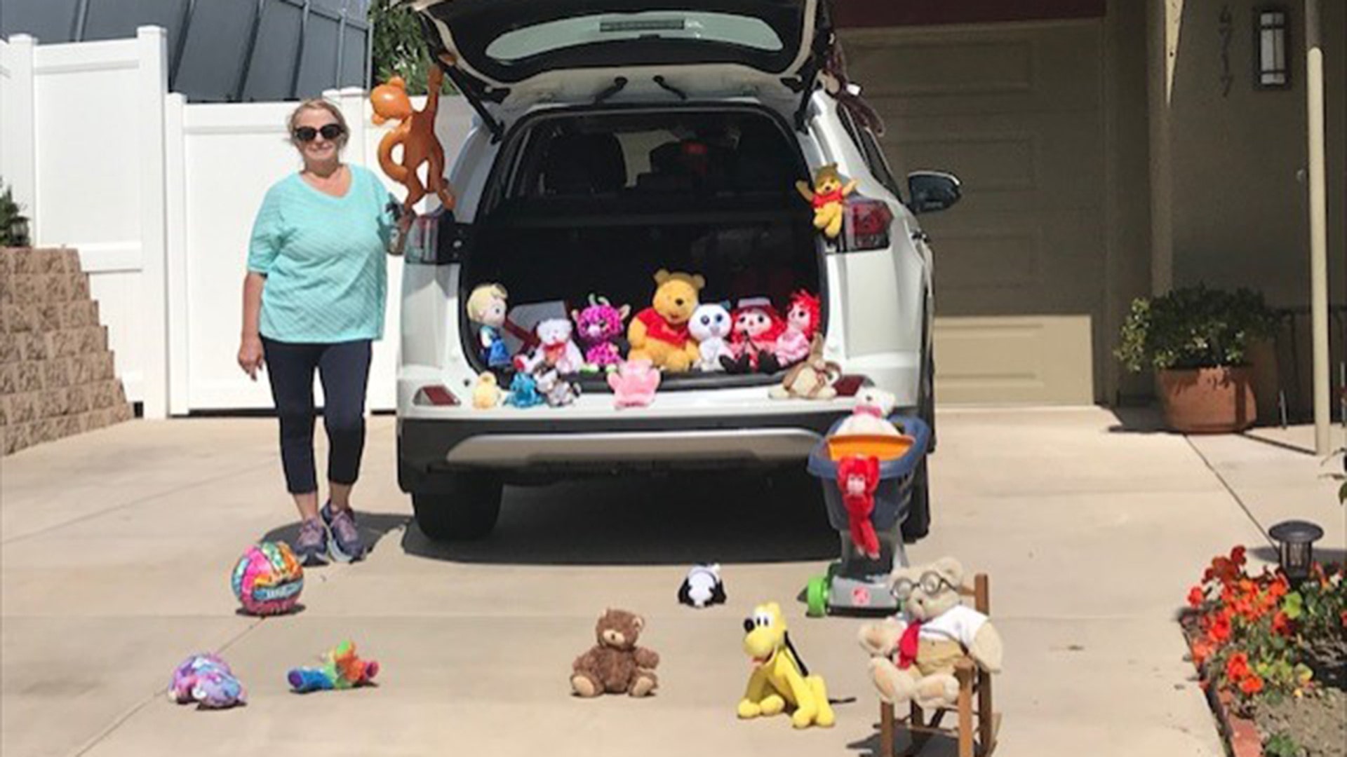 My wife was waiting for her six yr old granddaughter to just drive by, stay in the car due to quarantine restrictions in San Diego. My wife usually sees our granddaughter on a daily basis, because she picks her up from school everyday. So she decided to fill the car, and driveway with her stuffed animals to say hello. John Harris