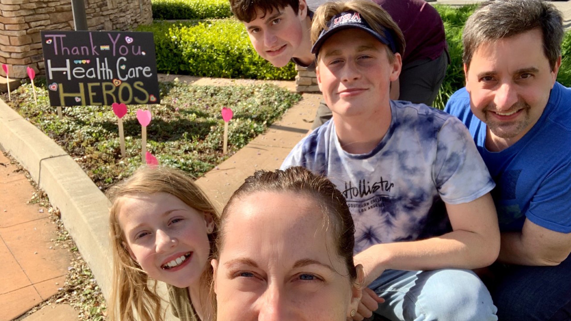 Yesterday our family gave the entrance/exit to the hospital in our little city of Lodi in CA a little “Heart Attack”. We took paper hearts and taped them to paint stir sticks then peppered the drive way with our support for all our local health care hero’s. At first the kids were embarrassed by their mom who forced them to participate, but by the time we left (people were smiling, honking, giving thumbs up and rolling down windows to thank us) they were really happy to have participated. This was a great lesson for our family- little gestures can have a big impact! Lizzie Perkins