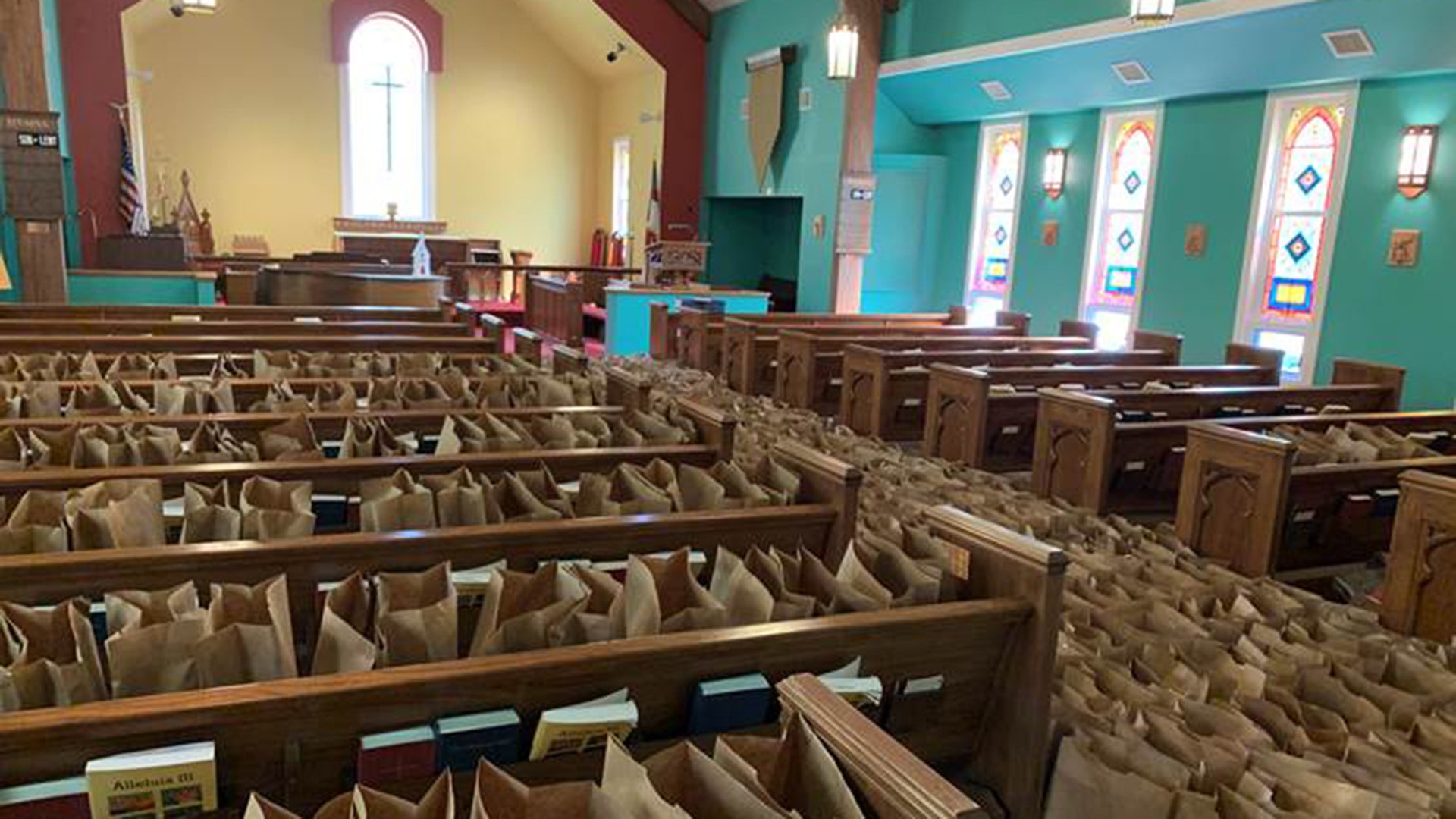 St. Mary’s Episcopal Church in Jasper, Alabama has operated a food bank for years, and we are one of the largest food banks in Walker, County. When the order was announced that schools were to be closed, the Walker Area Community Foundation organized a program to help feed the children who would normally be fed at school and others who would be impacted by this emergency. We set up distribution points across the county to provide hot meals and to distribute groceries to children and adults. Raising Arrows, a non-profit that provides meals to school children, prepared about 2,000 hot meals each day. St. Mary’s handled the distribution of groceries. In a two week period, we bagged and distributed over 8,000 bags of groceries. This is approximately the volume we handle in a year. St. Mary’s turned the Parish hall into a food warehouse and bagging facility. When we ran out of room to store bags, we used the church. This is the result, pews of grocery bags ready to be sent to distribution points across the county. There are numerous groups participating in this effort: churches, non-profits and others. There have been hundreds of volunteers, and many more who have donated to this effort to help our friends and neighbors. It has been a blessing to all of us. Food pantries across the country have been there every day, distributing food to people in need, and they will continue to be a source for food and assistance. I cannot say enough about the people at Feeding Alabama and Feeding America who make this possible. Mike McClendon St. Mary’s Episcopal Church Food Bank Jasper, Alabama