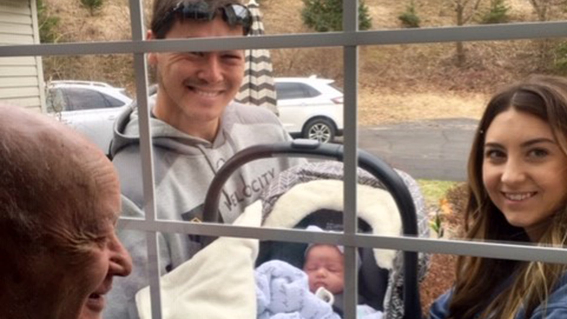 Mitch and Lauren Brown, Rochester, MN, show their recently-born daughter, Raleigh, to their great grandfather, Ned Brown, for the first time.