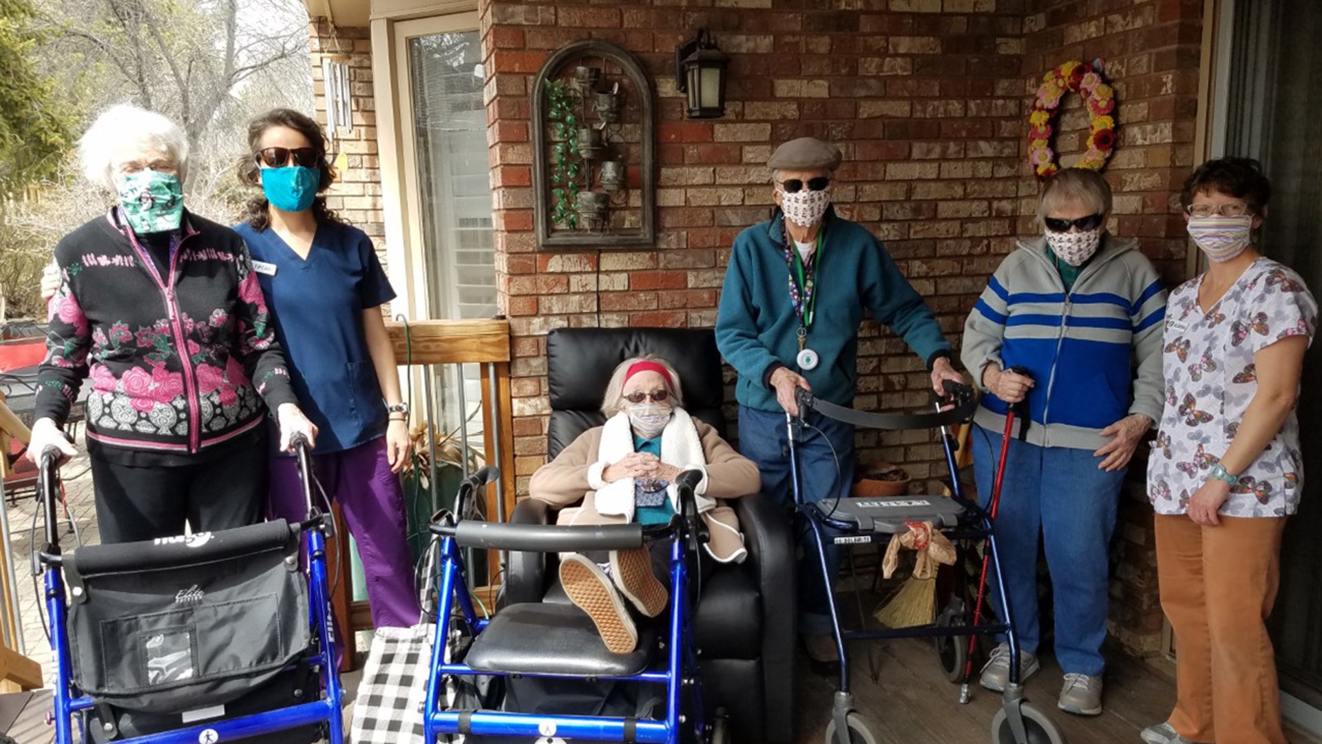 Residents and caregivers catch some rays of Spring sunshine on the patio. Trying out some new handmade face masks donated by friends and family. Monarch Greens Residential Assisted Living Home - 4.5.20, Fort Collins, CO Erin Ellis Monarch Greens Assisted Living A Home For Life