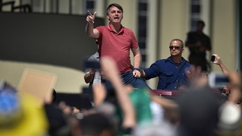 Brazil's Bolsonaro flouts coronavirus social distancing rules, coughs during speech at pro-military protest
