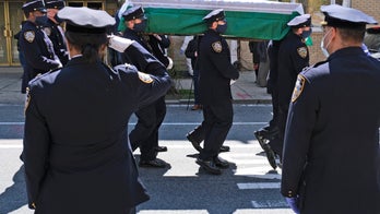New York police officers wear masks during funeral for 'revered' commander who died from coronavirus