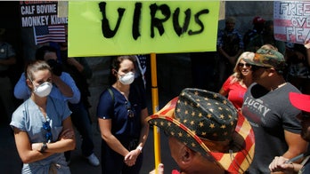 Arizona coronavirus unit nurse faces off with anti-lockdown protesters in shocking new photos