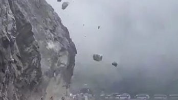 Driver stranded as boulders rain from mountainside like meteors, video reveals