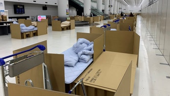 Japan airport sets up cardboard beds for travelers waiting for coronavirus test results