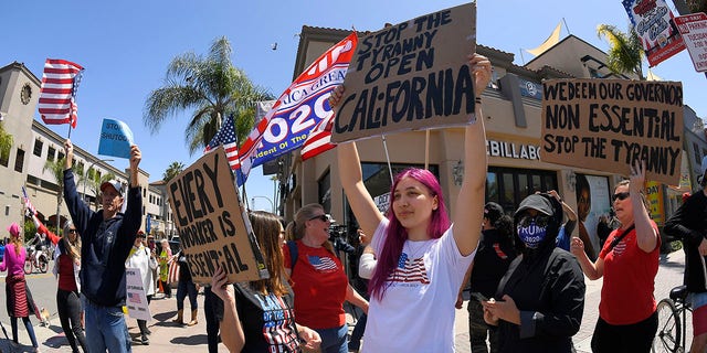 Protestors demonstrate against stay-at-home orders that were put in place due to the COVID-19 outbreak, Friday, April 17, 2020, in Huntington Beach, Calif. (Associated Press)