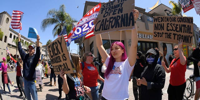 Protestors demonstrate against stay-at-home orders that were put in place due to the COVID-19 outbreak, Friday, April 17, 2020, in Huntington Beach, Calif. (Associated Press)