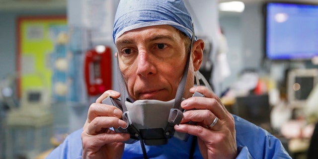 Dr. Anthony Leno, Director of Emergency Medicine, pauses at the end of his shift at St. Joseph's Hospital in Yonkers, N.Y. (AP Photo/John Minchillo)