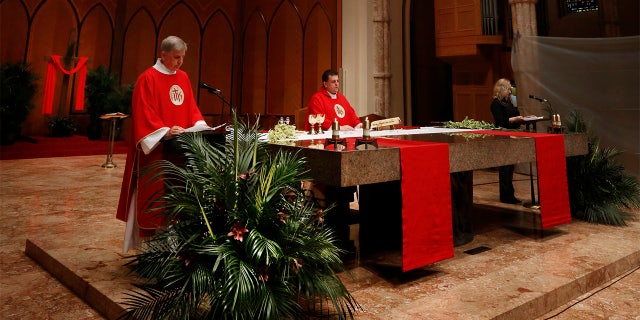 Father Marek Smolka, Associate Pastor and Director of Liturgy at Holy Name Cathedral, was the main celebrant during Mass taped in Polish for Palm Sunday on April 3, 2020 at Holy Name Cathedral in Chicago. In light of COVID-19 pandemic where all public Catholic Liturgies have been suspended since March 15, Masses have been taped and live-streamed in 3 languages for the faithful to worship online. (Karen Callaway/Chicago Catholic)