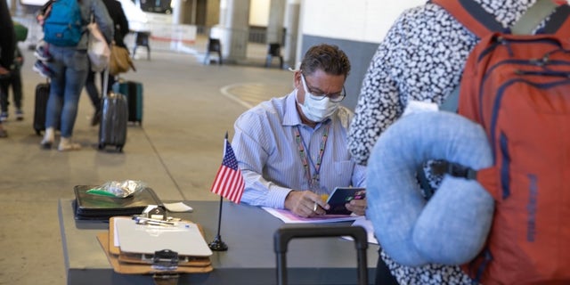 U.S. citizens checking in for their evacuation flight out of Johannesburg, South Africa.