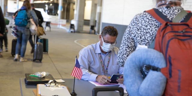 U.S. citizens checking in for their evacuation flight out of Johannesburg, South Africa.