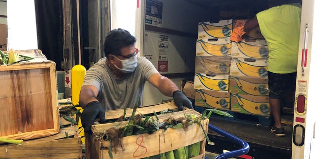 A worker unloads a delivery of produce at Second Harvest Food Bank of Central Florida (Erika Spence, Second Harvest Food Bank).