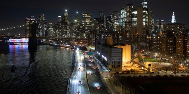 Cars head along FDR Drive next to the Manhattan skyline Thursday, March 26, 2020, during the coronavirus outbreak in New York. (AP Photo/Mark Lennihan)